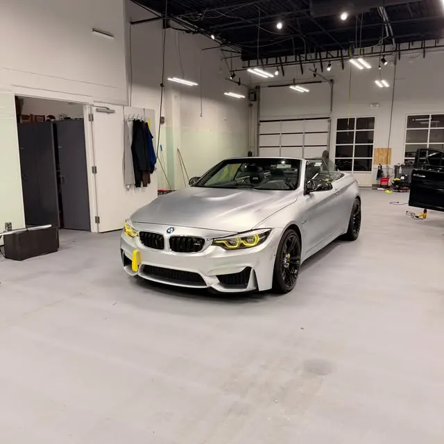 White BMW at an indoor shop